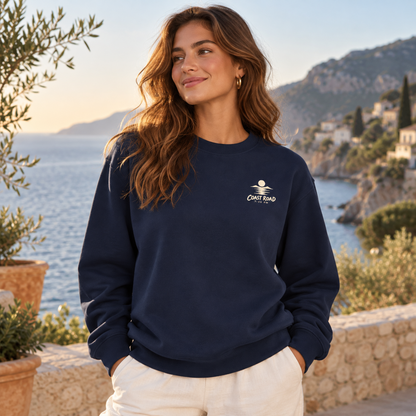 Coast Road 7:20 PM True Navy sweatshirt on a female model, front lifestyle view with the cream left-chest mark.