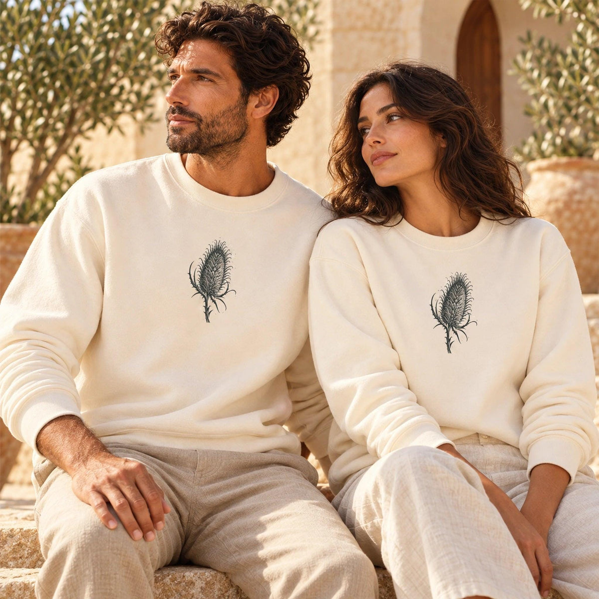 Male and female models wearing Cardó Ivory lightweight crewnecks with original centered botanical artwork