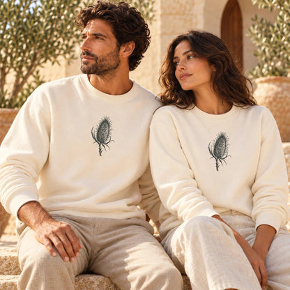 Male and female models wearing Cardó Ivory lightweight crewnecks with original centered botanical artwork