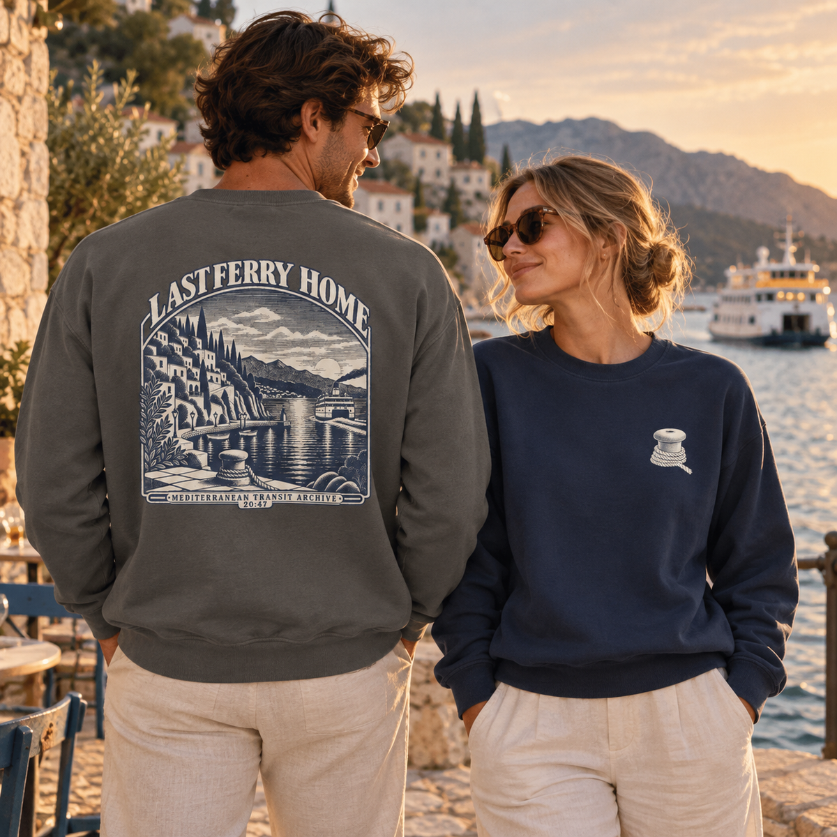 Last Ferry Home Pepper and True Navy sweatshirts styled at a Mediterranean harbor at sunset.