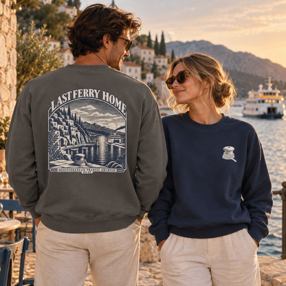 Last Ferry Home Pepper and True Navy sweatshirts styled at a Mediterranean harbor at sunset.