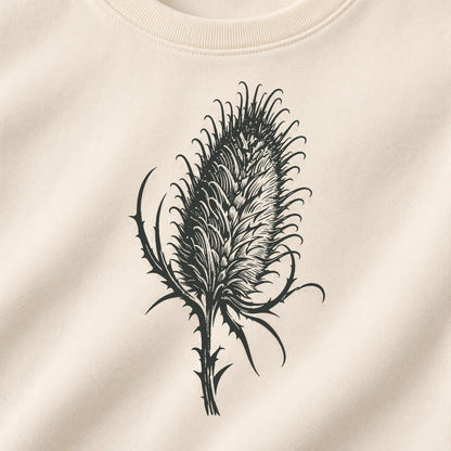 Detailed close-up of the original Cardó charcoal teasel artwork printed on Ivory sweatshirt fabric
