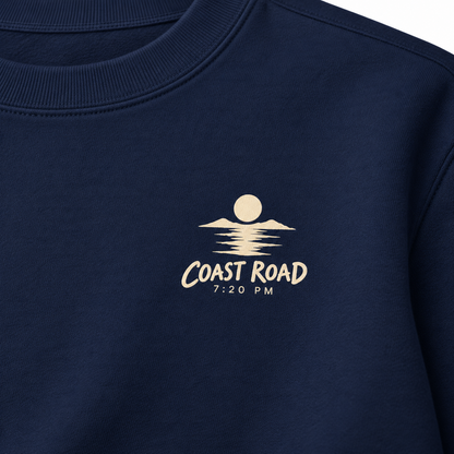 Close-up of the Coast Road 7:20 PM cream left-chest print on True Navy sweatshirt fabric.