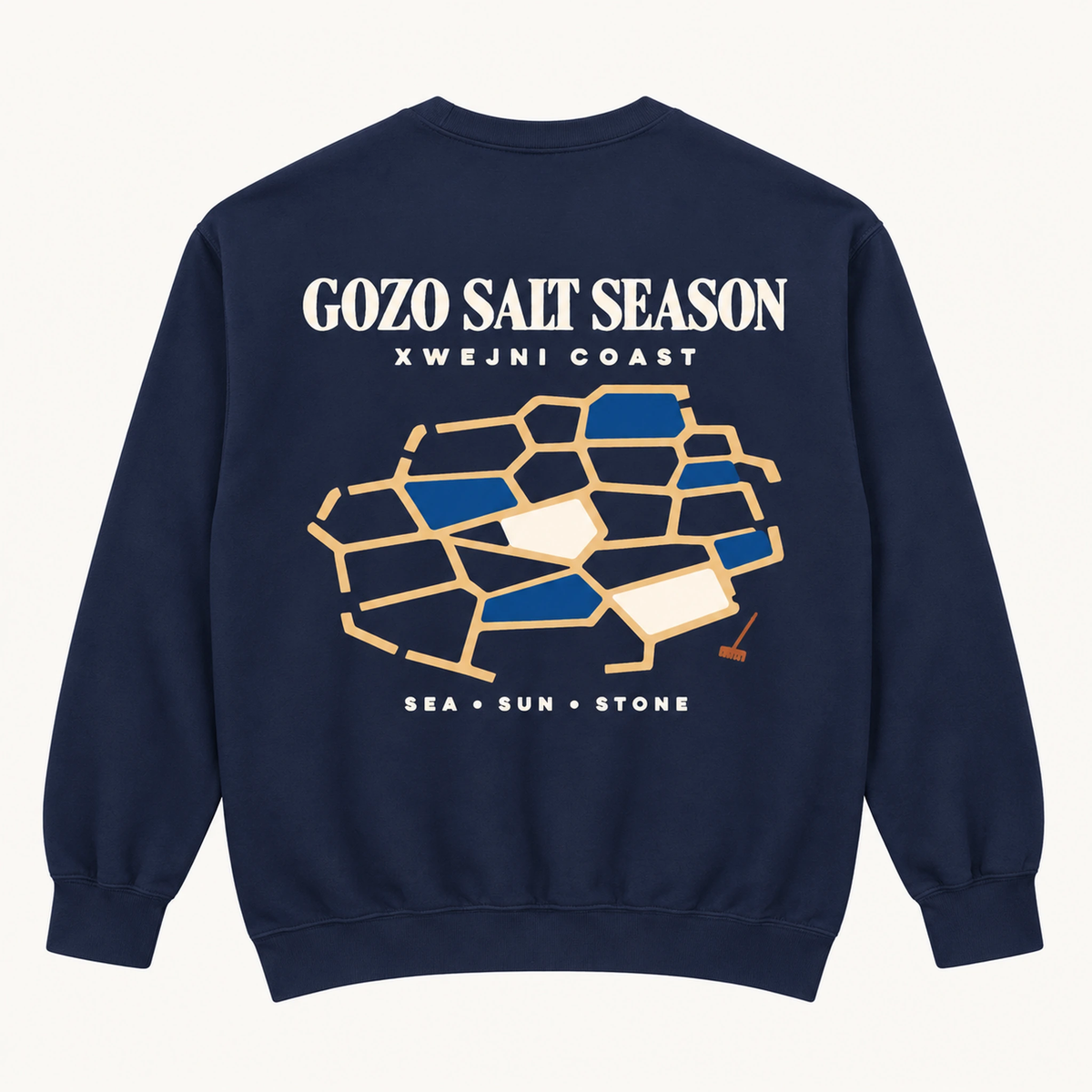 True Navy Gozo Salt Season sweatshirt flat lay showing the large Xwejni salt-pan back print and Sea Sun Stone footer.