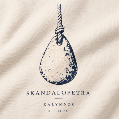 Close macro view of Skandalopetra Kalymnos diving-stone navy front design on Ivory crewneck