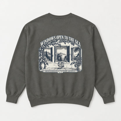 Windows Open to the Sea Pepper Comfort Colors 1566 sweatshirt back flat lay with full Mediterranean window artwork.