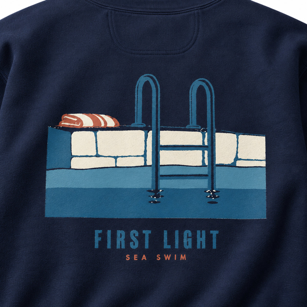 First Light Sea Swim True Navy sweatshirt close-up of the back sea ladder, stone edge and towel artwork