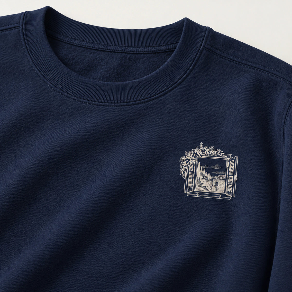 Windows Open to the Sea True Navy sweatshirt left-chest window mark and garment-dyed fabric detail.