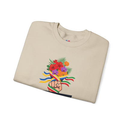 Folded beige sweatshirt with a colorful design of a raised fist with flowers and flags on a white background