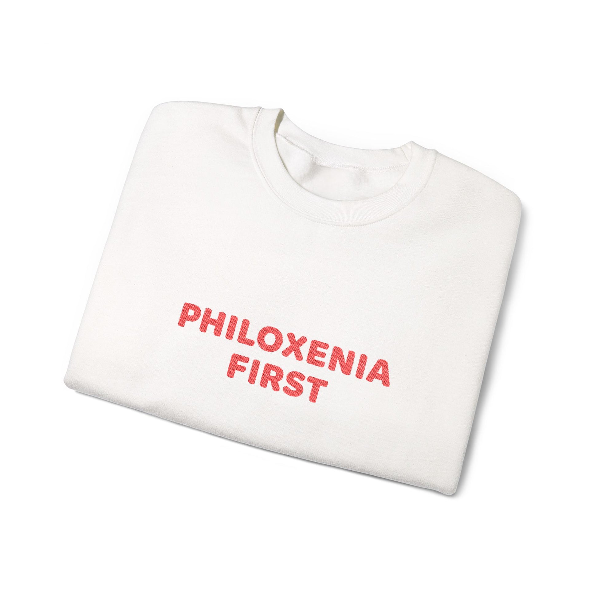 White sweatshirt with 'PHILOXENIA FIRST' text in red on a white background
