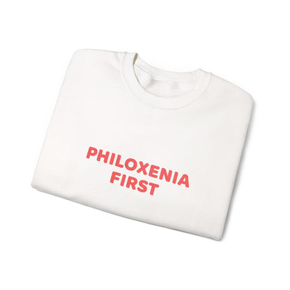 White sweatshirt with 'PHILOXENIA FIRST' text in red on a white background
