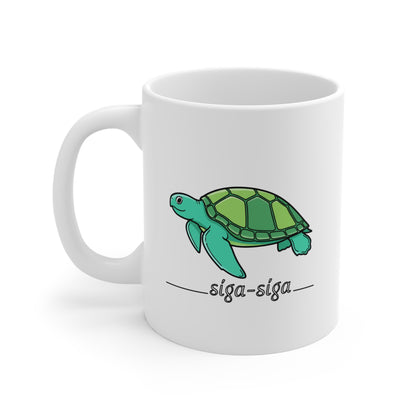 White mug with a green turtle illustration and 'siga-siga' text on a white background