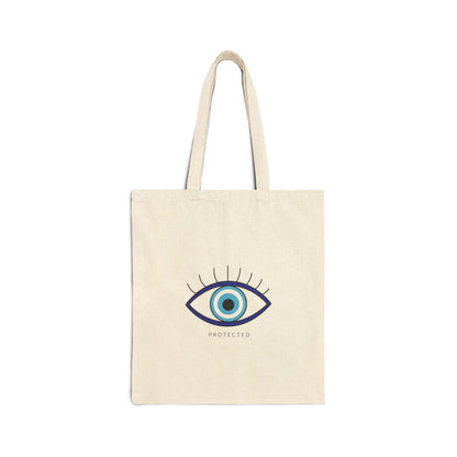 Beige tote bag with an eye design and 'PROTECTED' text on a white background