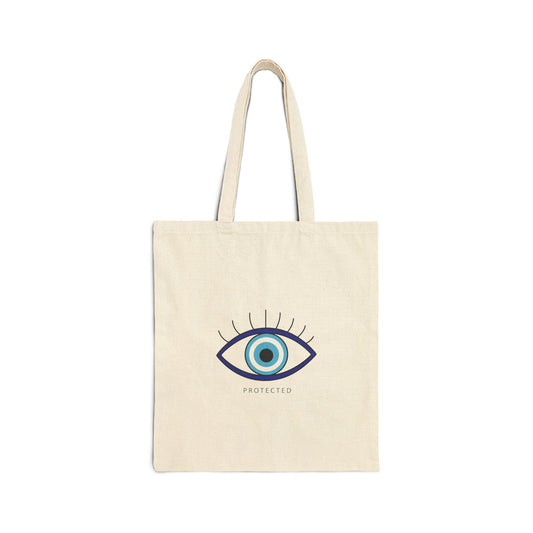 Beige tote bag with an eye design and 'PROTECTED' text on a white background
