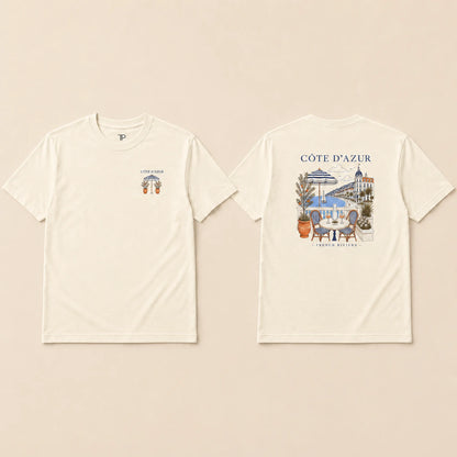 Two cream-colored short-sleeve t-shirts shown flat against a light beige background, displaying the front and back designs. The front features a small graphic on the left chest with the text 'COTE D'AZUR' and a small crest.