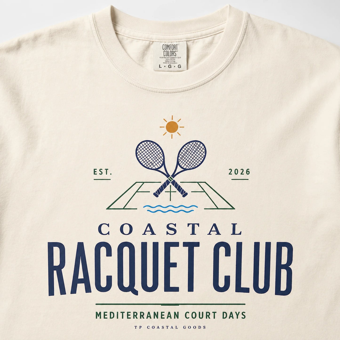 Beige t-shirt with 'Coastal Racquet Club' graphic design on a white background