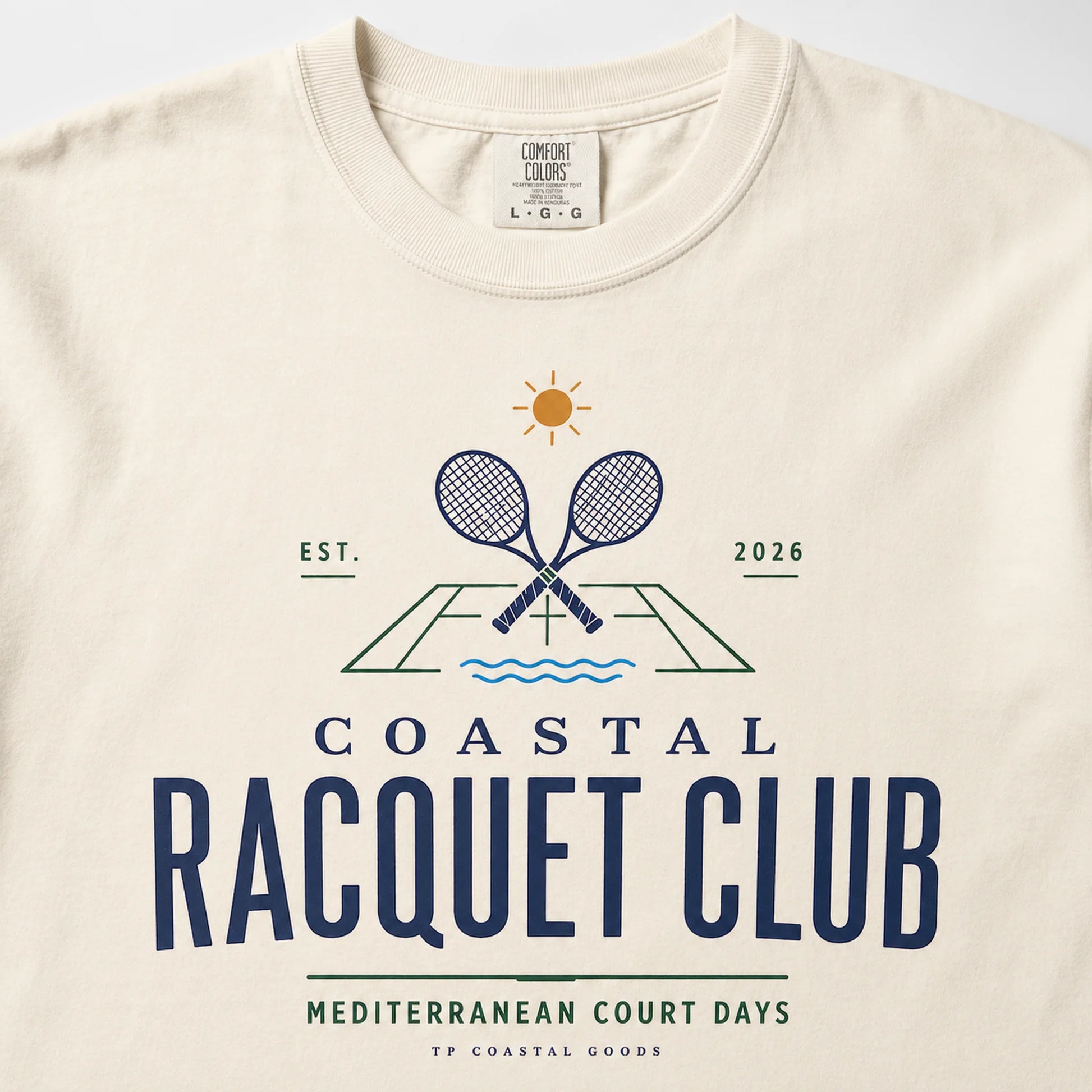 Beige t-shirt with 'Coastal Racquet Club' graphic design on a white background