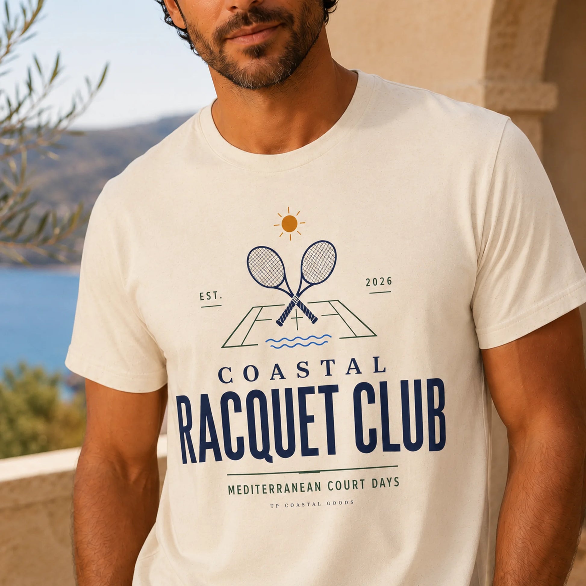 TP HERO: Man wearing a 'Coastal Racquet Club' t-shirt with a scenic background