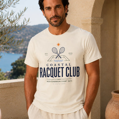 Man wearing a 'Coastal Racquet Club' t-shirt with a scenic background