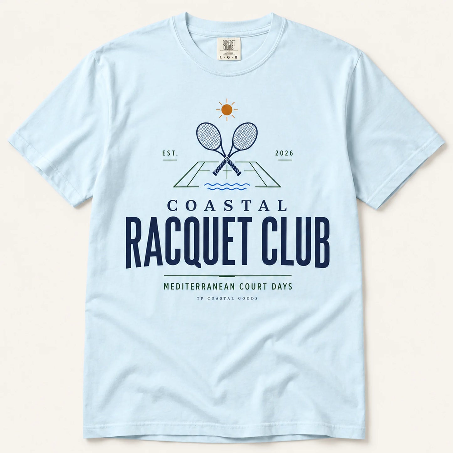 Light blue t-shirt with 'Coastal Racquet Club' graphic on a beige background