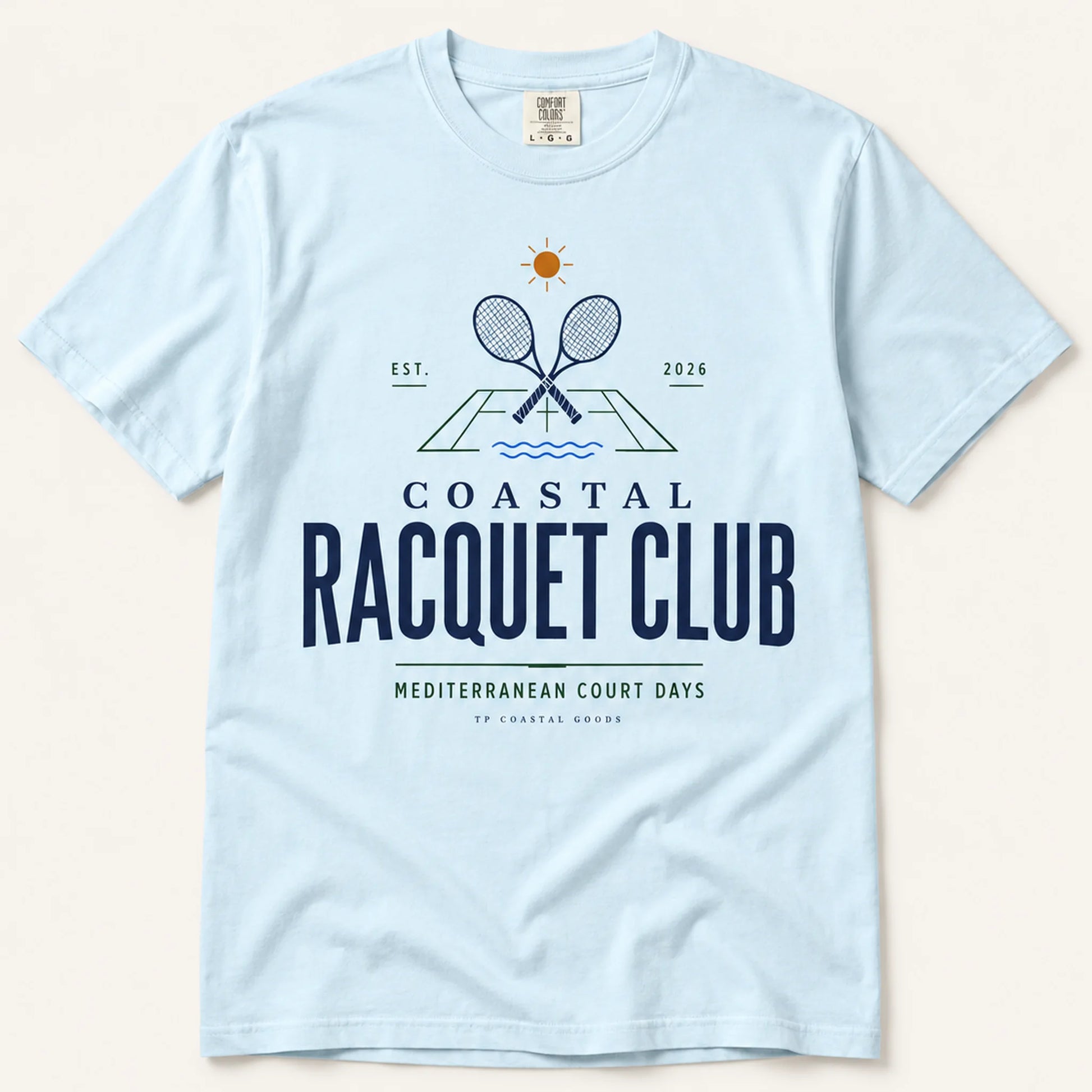 Light blue t-shirt with 'Coastal Racquet Club' graphic on a beige background