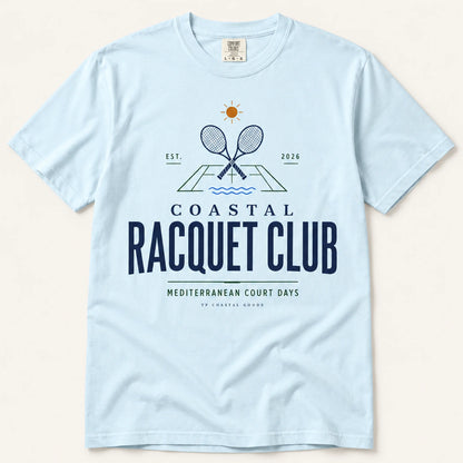 Light blue t-shirt with 'Coastal Racquet Club' graphic on a beige background