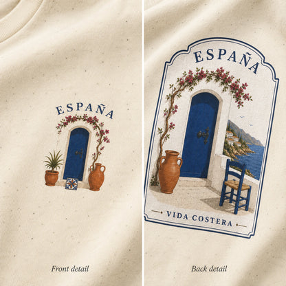 Two close-up views of the same cream-colored garment showing printed Spain-themed artwork. The left panel shows a small front detail with the word ESPAÁNA above an arched blue door, flower garland, two terracotta pots, and a small tile motif.