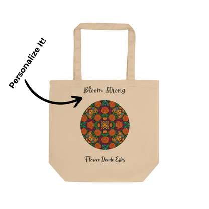 Beige tote bag with colorful circular design and text on a white background