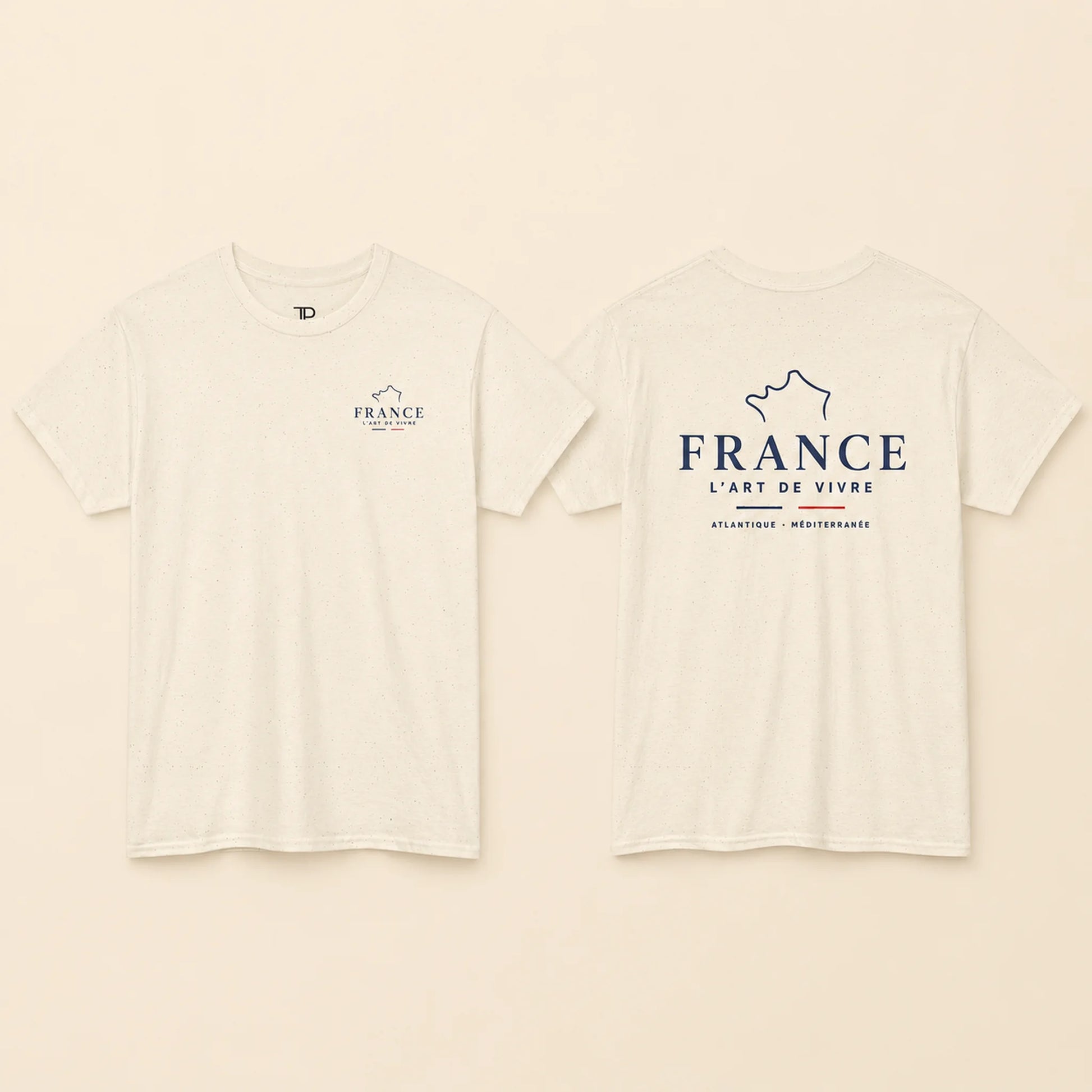 Two views of an off-white short-sleeve t-shirt on a light beige background. The front view shows a small navy blue graphic on the left chest with the word 'FRANCE' and a mountain outline.