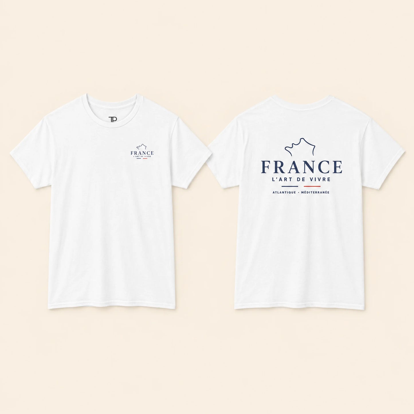 Two white short-sleeve T-shirts shown flat against a light beige background, displaying the front and back views. The front features a small navy blue logo on the left chest, and the back features a larger navy blue graphic with the text 'FRANCE L'ART DE VIVRE' and 'ATLANTIQUE - MEDITERRANEE'.