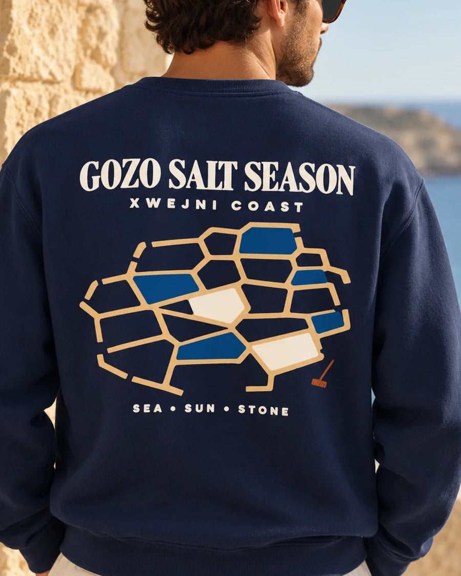 Close-up model view of the Gozo Salt Season sweatshirt in True Navy, with the Xwejni salt-pan back design dominating the frame.