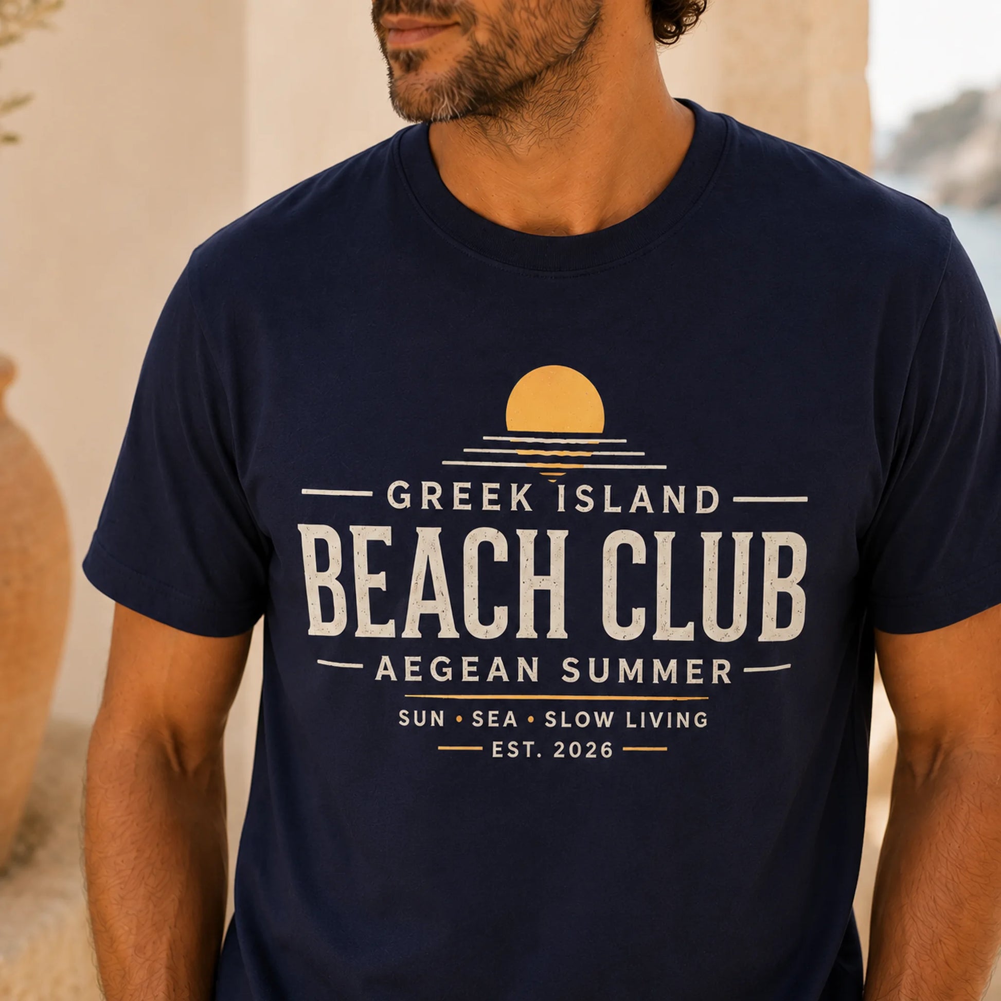 TP HERO: Person wearing a navy blue t-shirt with 'Greek Island Beach Club' text and design.