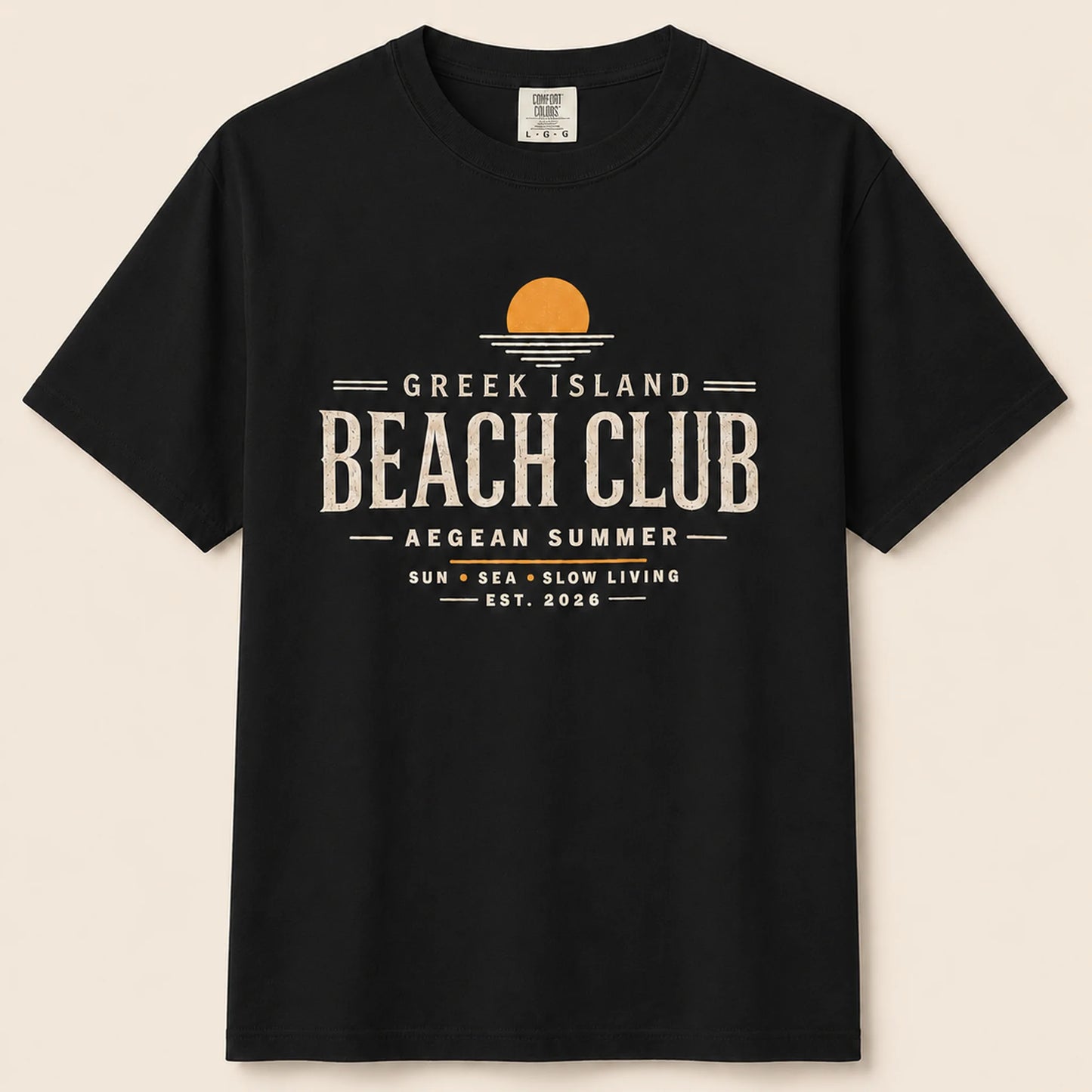 Black t-shirt with 'Greek Island Beach Club' text and design on a beige background
