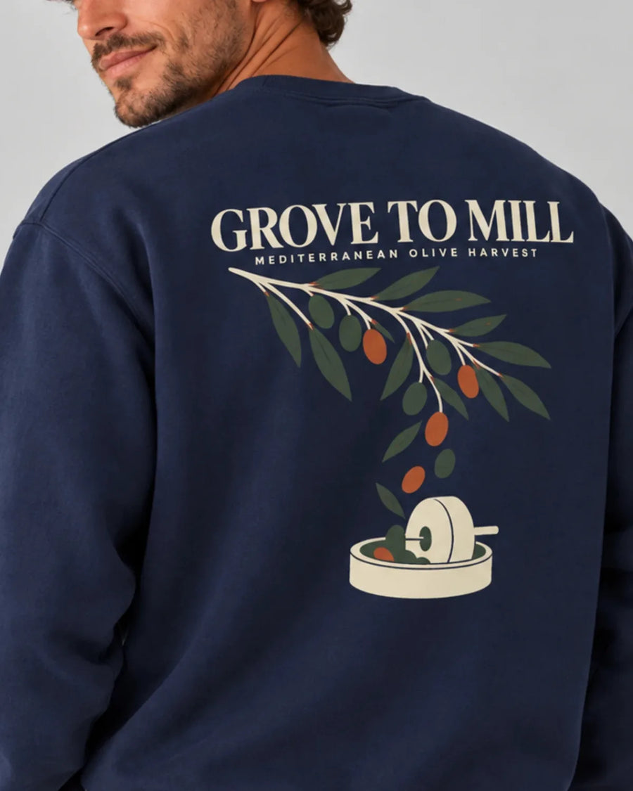 Model wearing the ToldPrint Grove to Mill Mediterranean Olive Harvest sweatshirt in True Navy with large back print