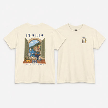 Two cream-colored t-shirts shown against a light gray background, displaying the front and back views. The back of the shirt features a large graphic print of an Italian coastal scene with the text 'ITALIA' and 'VITA SUL MARE'.