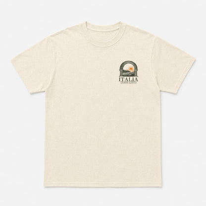 A light beige heathered short-sleeve t-shirt with a small graphic on the left chest depicting a scenic archway with a sunset and the text 'ITALIA'.