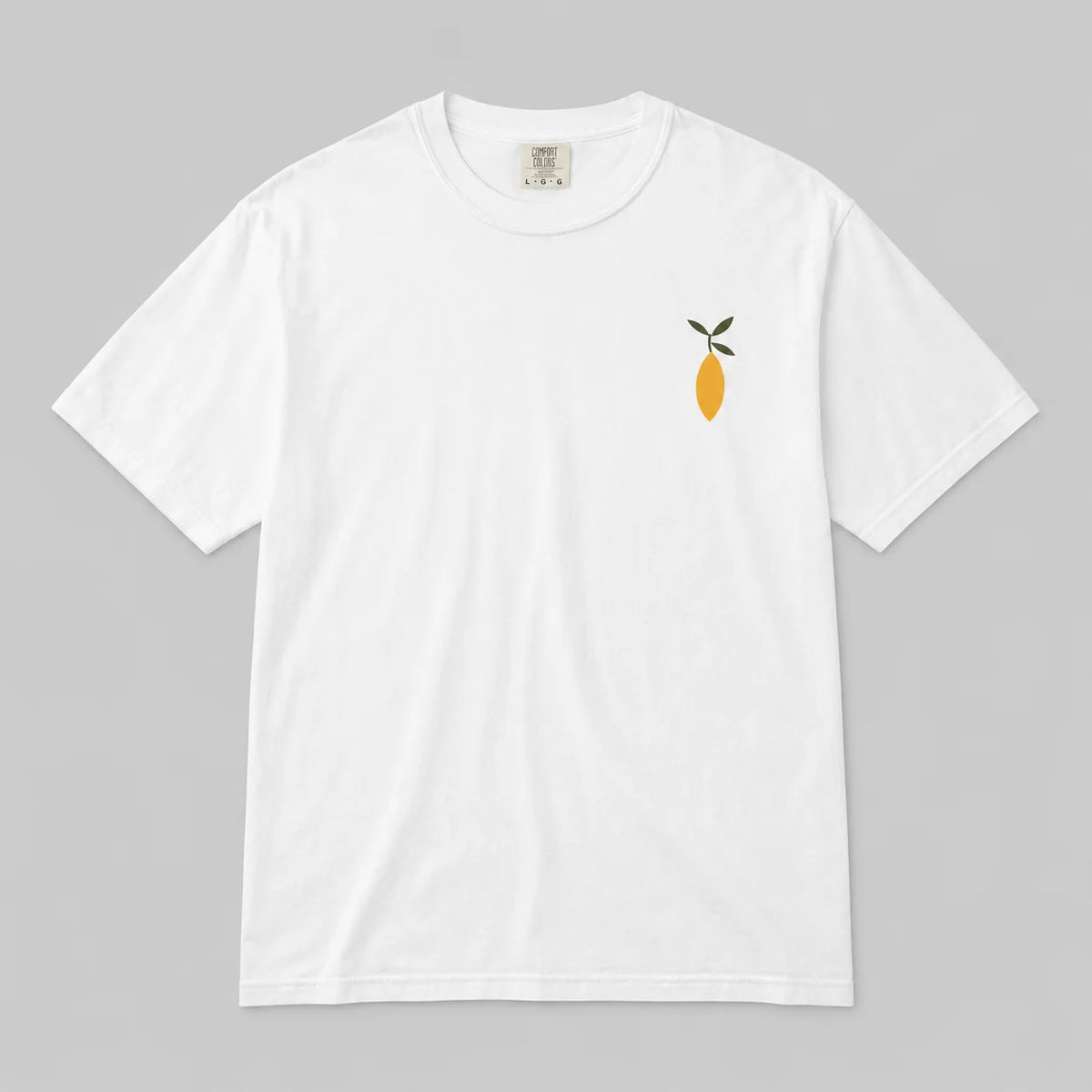 A white short-sleeve crewneck t-shirt featuring a small graphic of a yellow lemon with green leaves on the left chest, displayed flat against a neutral gray background.