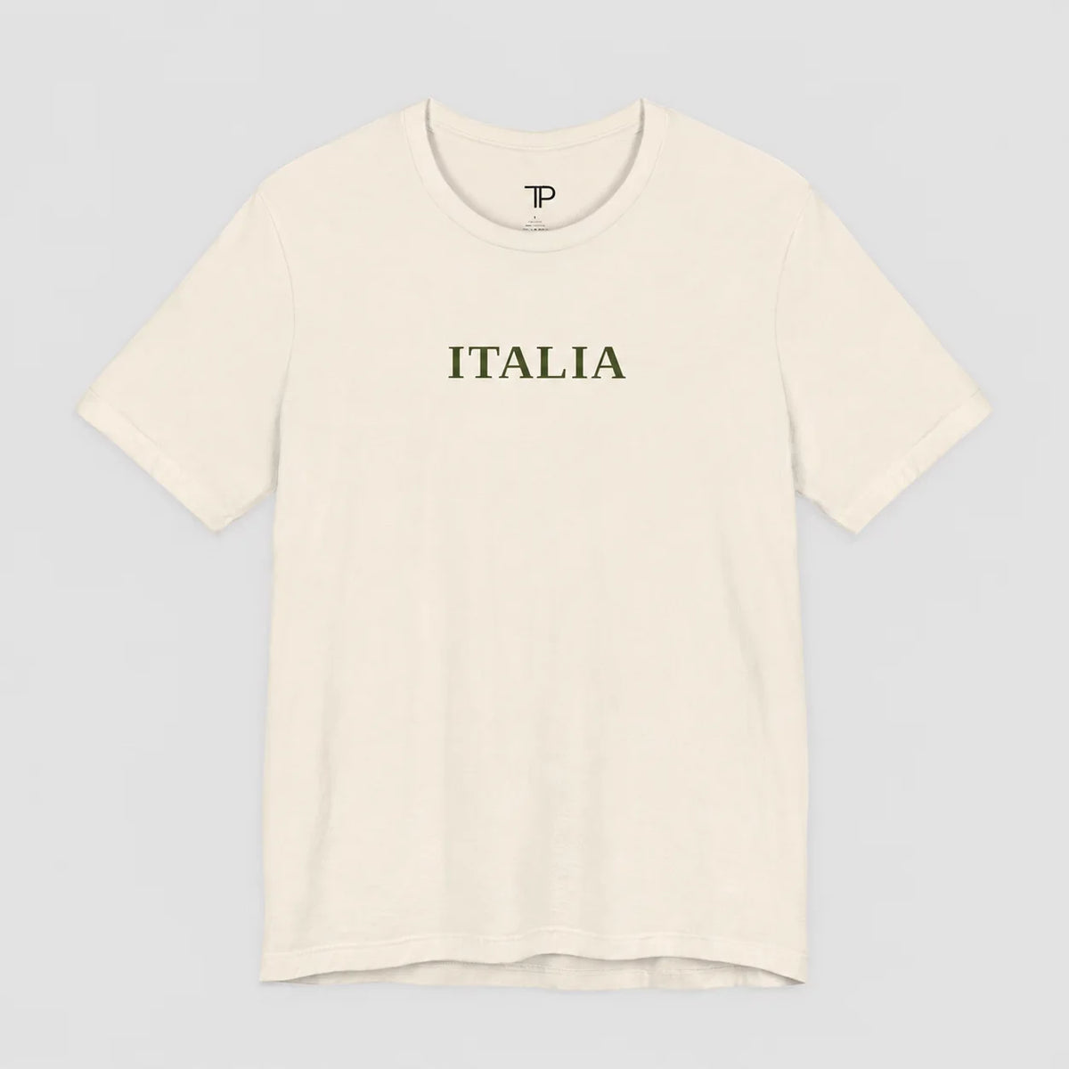An off-white crewneck t-shirt with the word 'ITALIA' printed in dark olive green across the chest, displayed on a neutral light gray background.