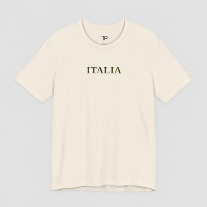 An off-white crewneck t-shirt with the word 'ITALIA' printed in dark olive green across the chest, displayed on a neutral light gray background.