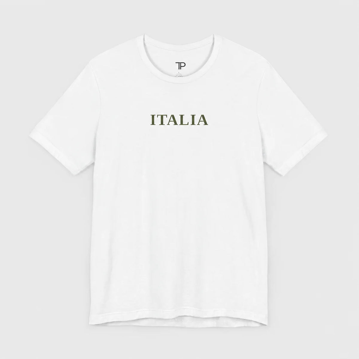 A white short-sleeve crewneck t-shirt with the word 'ITALIA' printed in olive green serif letters across the chest, displayed on a light gray background.