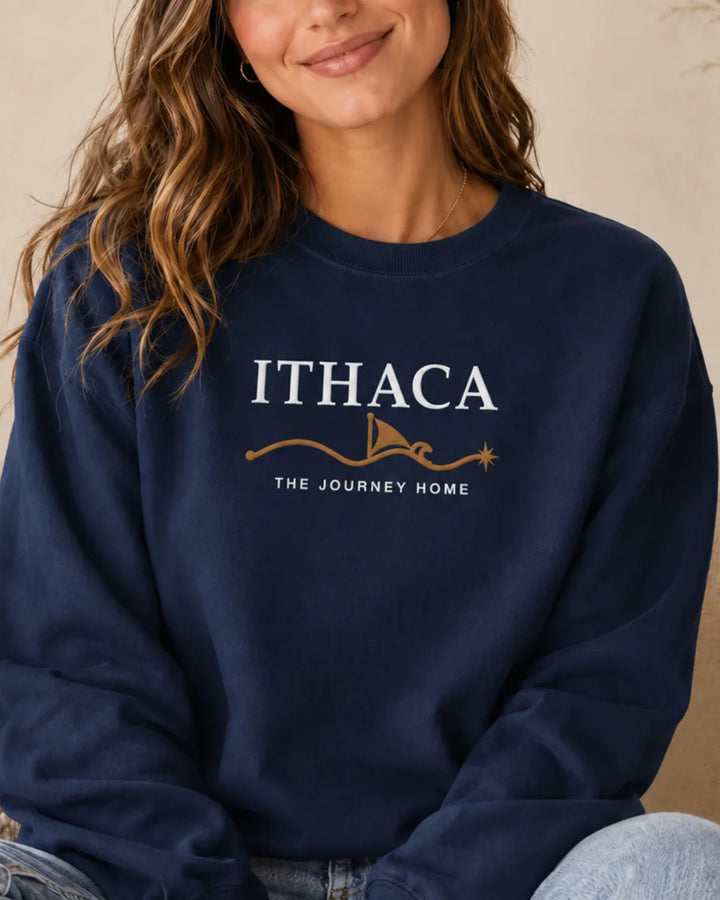 Woman wearing the ToldPrint Ithaca — The Journey Home embroidered sweatshirt in True Navy, featuring white and warm-gold center-chest embroidery.