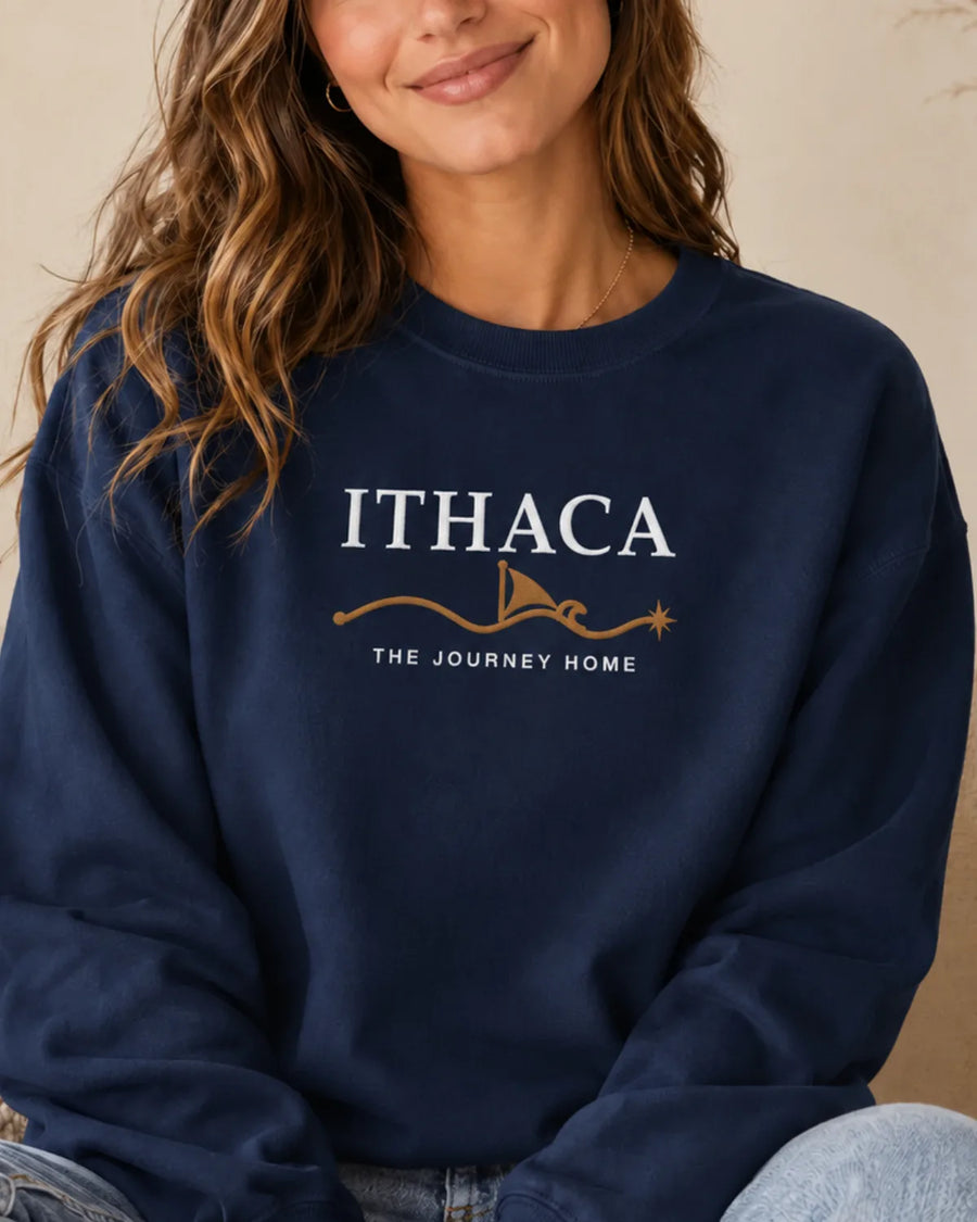 Woman wearing the ToldPrint Ithaca — The Journey Home embroidered sweatshirt in True Navy, featuring white and warm-gold center-chest embroidery.