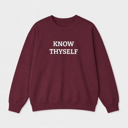 A crewneck sweatshirt in maroon with the words 'KNOW THYSELF' embroidered in white block letters across the chest, displayed on a clean light gray background.