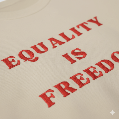 Text 'EQUALITY IS FREEDOM' embroidered on a beige background