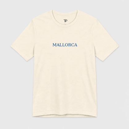 An off-white crewneck t-shirt with 'MALLORCA' printed in blue serif letters across the chest, displayed on a light gray background.