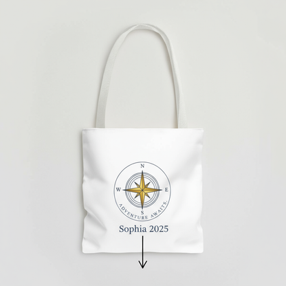 White tote bag with compass design and text on a light gray background