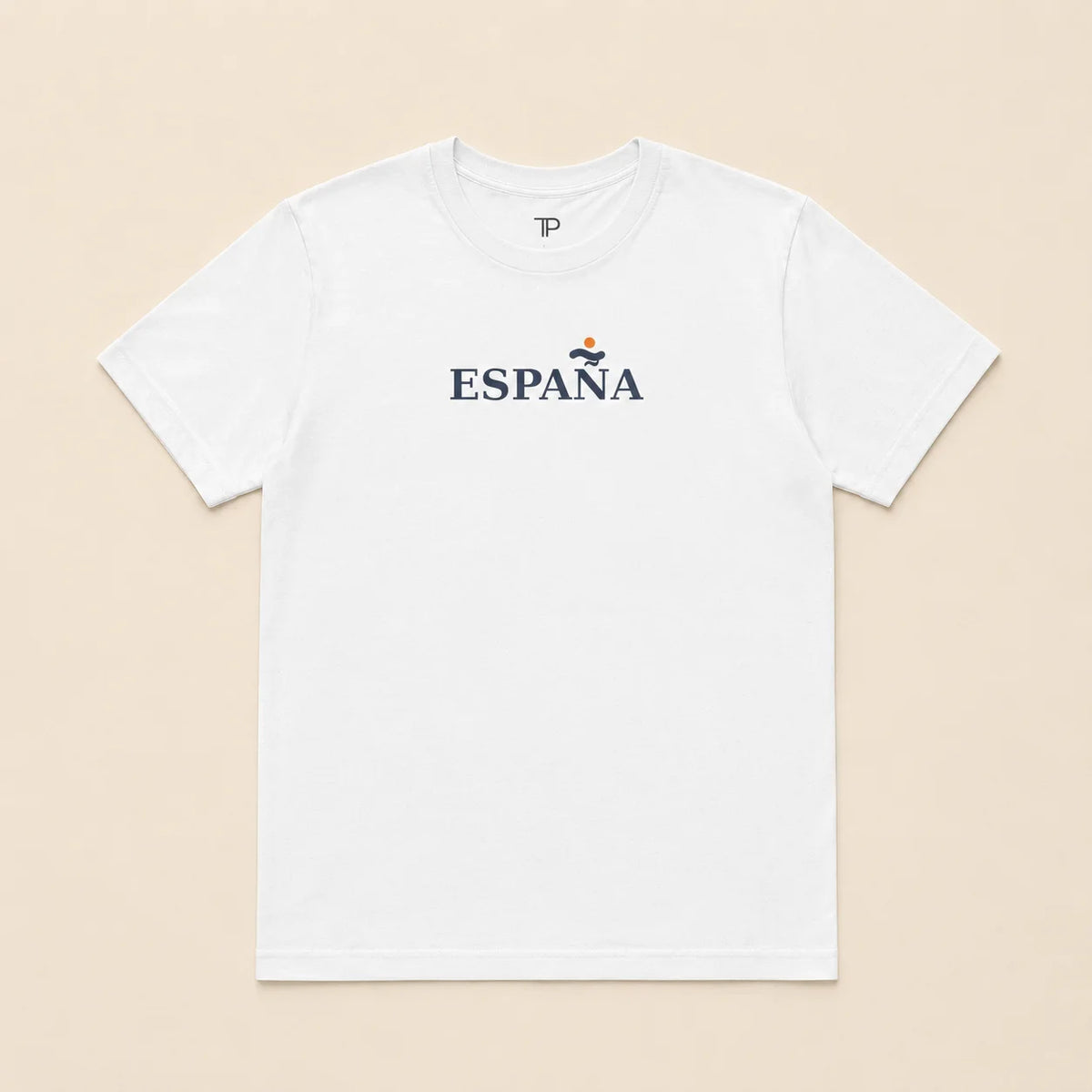 A white short-sleeve crewneck t-shirt with 'ESPANA' printed in navy blue across the chest, featuring a small red and yellow emblem above the text, laid flat on a light beige background.