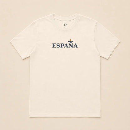 An off-white short-sleeve crewneck t-shirt with 'ESPAÑA' printed in navy blue across the chest, featuring a small yellow and blue graphic above the text, laid flat on a light beige background.