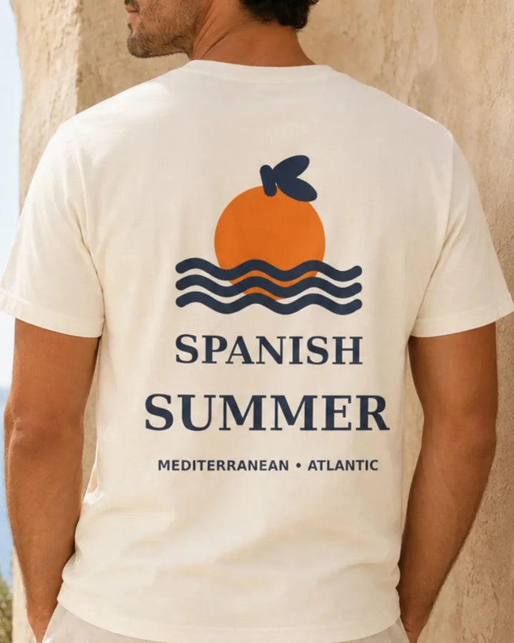 Ivory unisex T-shirt featuring the Spanish Summer back graphic with an orange sun, navy waves and “Spanish Summer – Mediterranean • Atlantic” text.