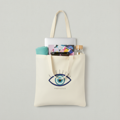 Tote bag with eye design and text 'PROTECTED' on a gray background